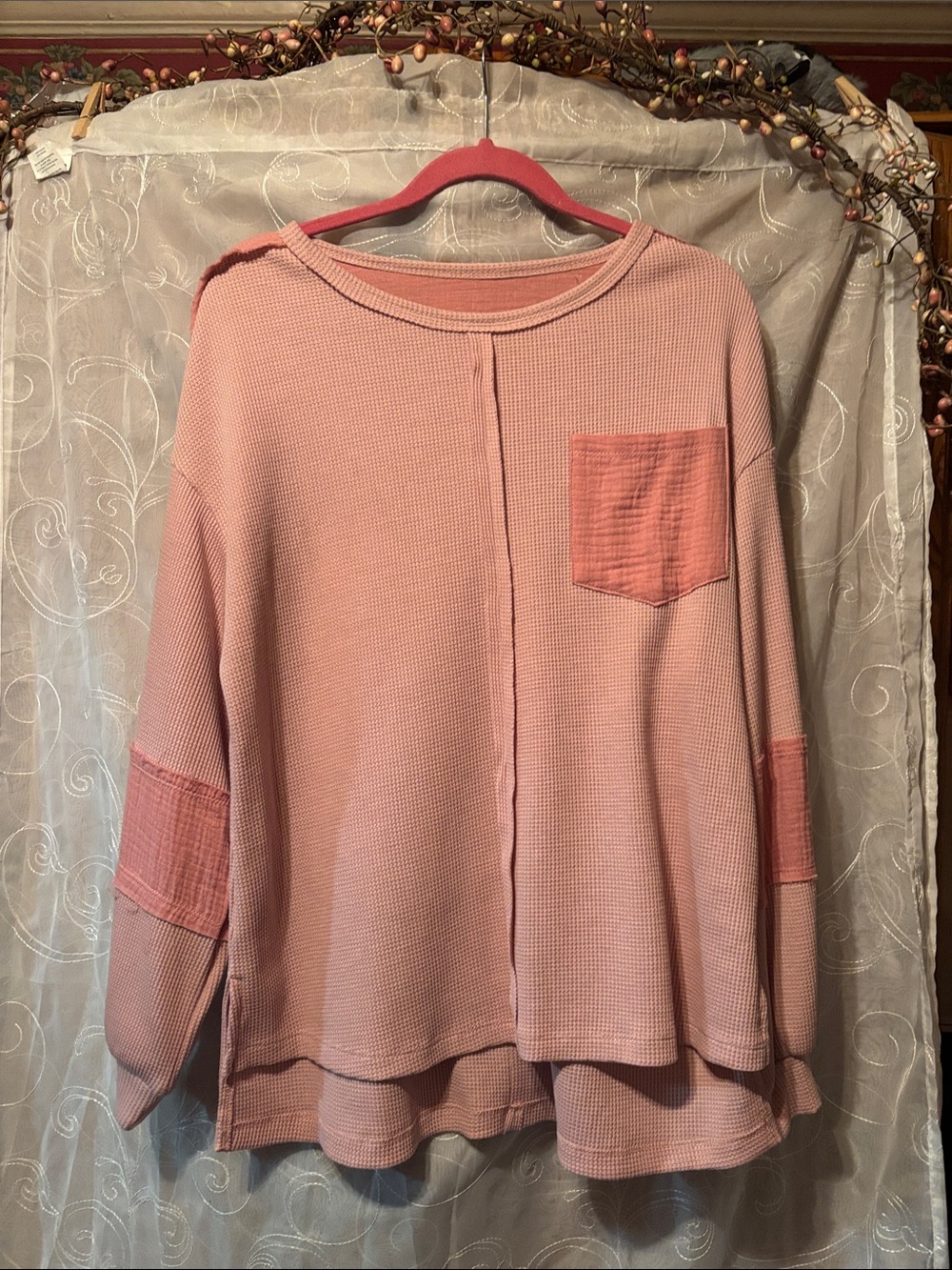Peach colored loose fitting top. Fits more like a M/L. Very comfortable fit.